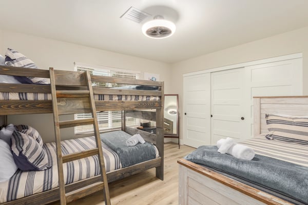 Spacious bedroom featuring custom bunk beds, updated flooring, and flexible accommodations for family and guests. A thoughtfully designed Scottsdale retreat.