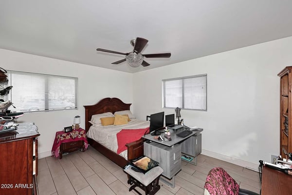 Enjoy a spacious primary bedroom with room for additional seating, workspace, or personal furnishings. Large windows and neutral finishes enhance the bright and comfortable atmosphere.