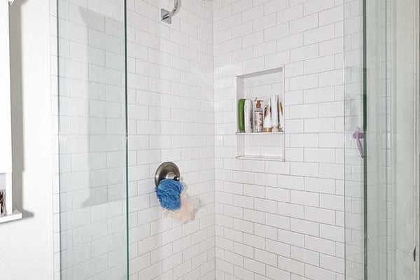 A spacious secondary bedroom with tile flooring, ceiling fan, and abundant natural light. The versatile floor plan easily accommodates guests, family members, or a home office setup.