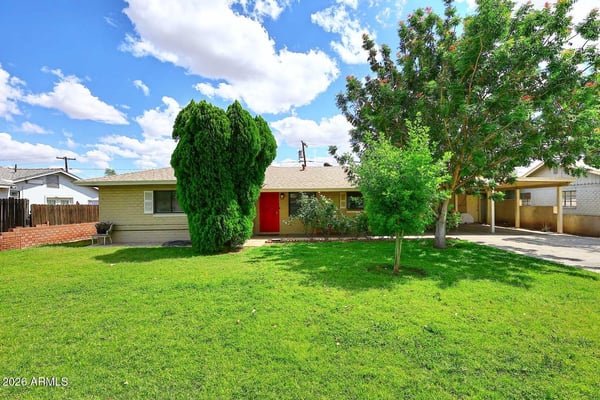 Attractive landscaping, mature shade trees, and a lush grass lawn enhance the curb appeal of this Phoenix home. The spacious front yard and covered parking create an inviting setting that stands out from the moment you arrive.