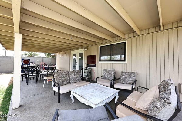 Designed for outdoor enjoyment, this covered patio includes ample room for conversation seating and entertaining. The generous covered structure adds valuable outdoor living space.
