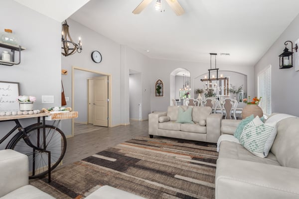 Featuring vaulted ceilings, abundant windows, updated flooring, and an open layout, this bright living room provides the perfect place to relax, entertain, or spend time with family.