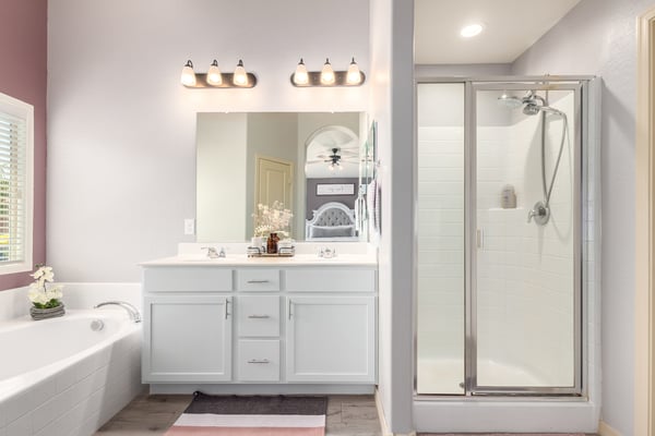 Enjoy a bright primary bathroom complete with dual vanities, a soaking tub, separate walk-in shower, and modern finishes that provide comfort and functionality for everyday living.