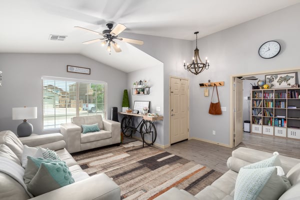 Filled with natural light and enhanced by vaulted ceilings, this spacious great room offers flexible living space that flows effortlessly into the dining area, making it perfect for entertaining.