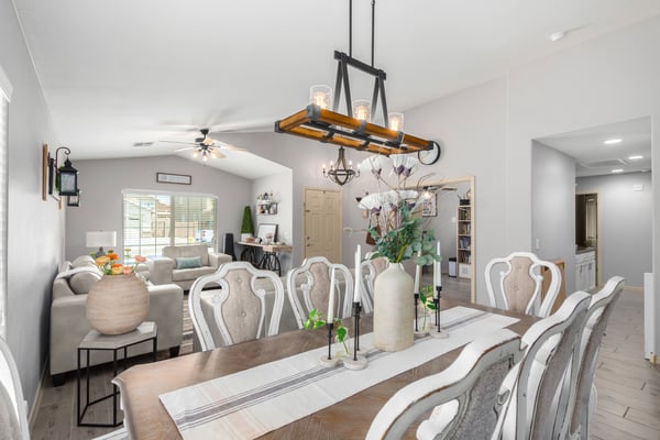 The spacious dining area features designer lighting, updated flooring, and a seamless connection to the living room, creating the perfect setting for everyday meals and special occasions.