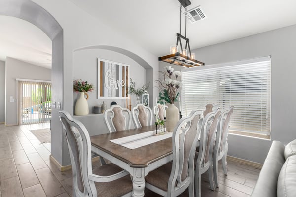 Gather family and friends in this spacious dining room featuring vaulted ceilings, designer lighting, updated flooring, and an open-concept layout that connects beautifully with the home's main living areas.