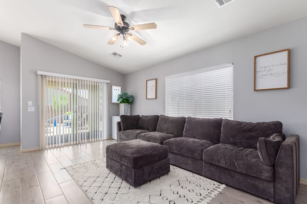Relax in this inviting family room featuring large windows, ceiling fan, updated flooring, and direct access to the backyard patio. The open layout makes entertaining effortless while maximizing natural light.