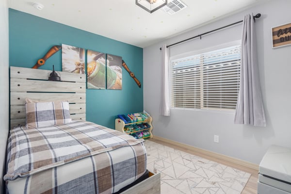 This bright bedroom features abundant natural light, updated flooring, and versatile space that's ideal for guests, a home office, hobby room, or growing household needs.