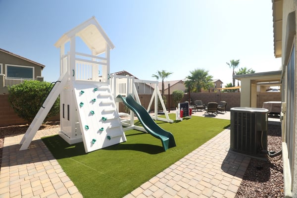 Families will appreciate the spacious backyard featuring a premium playset, artificial turf, paver walkways, and generous open space for recreation, entertaining, and everyday enjoyment.