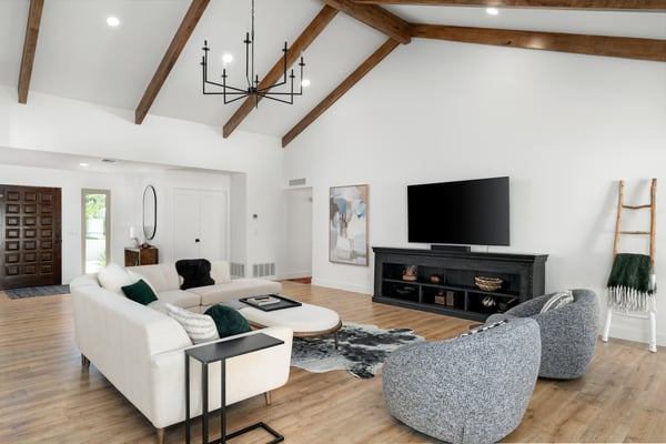 Architectural wood beams, soaring ceilings, and abundant natural light make this expansive great room the centerpiece of the home. The open design enhances comfort, functionality, and effortless entertaining.