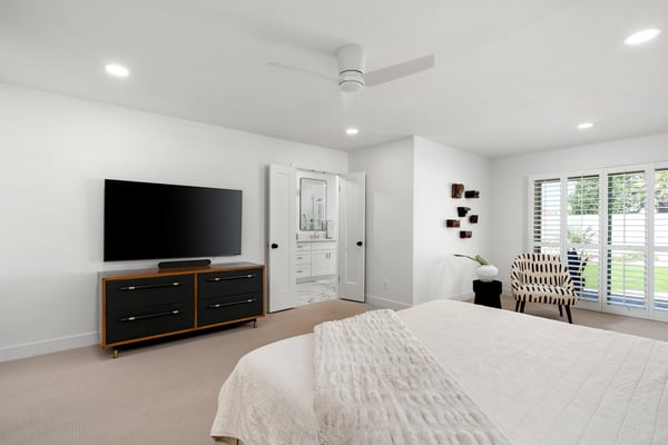 Enjoy a spacious owner's retreat complete with elegant finishes, abundant natural light, plantation shutters, and direct access to a beautifully updated ensuite bath, creating a luxurious private escape.