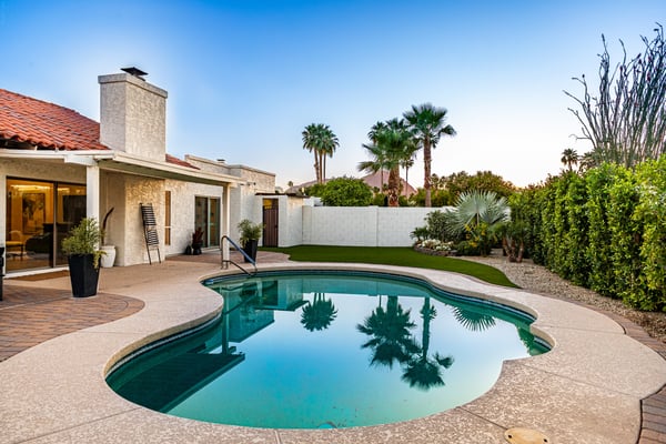Enjoy peaceful mornings and unforgettable evenings beside the sparkling pool, framed by mature landscaping and scenic mountain views. This outdoor retreat perfectly complements the home's indoor living spaces.
