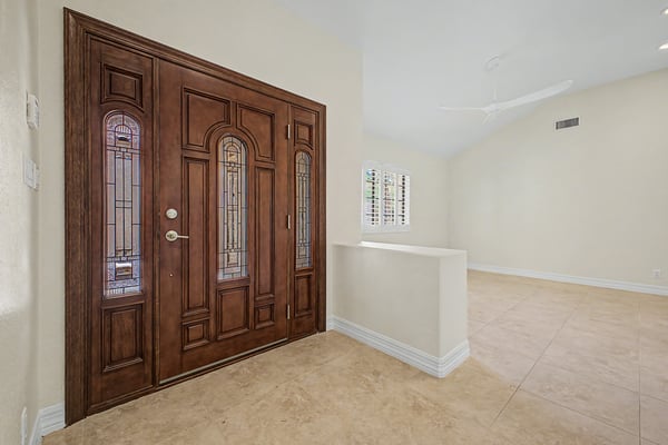The bright foyer features soaring ceilings, updated tile flooring, and an open design that immediately showcases the home's spacious layout and welcoming atmosphere.