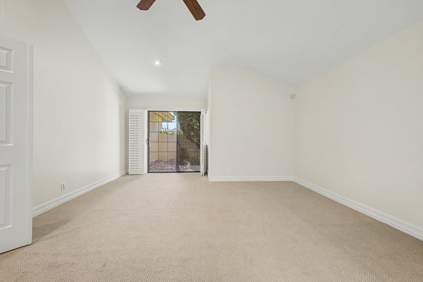 Bright and inviting primary bedroom with soaring ceilings, neutral d cor, updated finishes, generous floor space, and a relaxing atmosphere designed for everyday comfort.