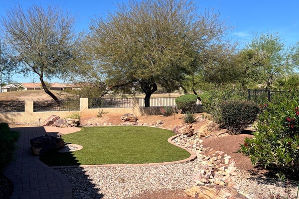 Enjoy peaceful golf course living with beautifully maintained artificial turf, mature shade trees, decorative desert landscaping, and picturesque White Tank Mountain views. This private outdoor space offers exceptional beauty with minimal upkeep.