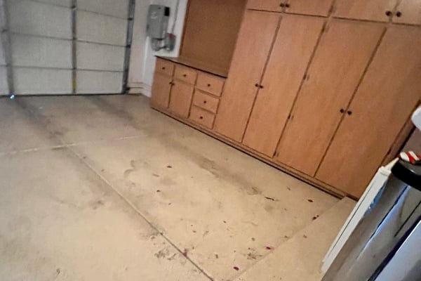 Two-car garage with extensive custom storage cabinets, built-in work area, and generous space for vehicles, tools, and recreational equipment, making organization simple and efficient.