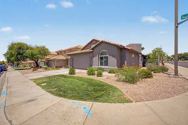 Wide exterior perspective highlighting the home's attractive landscaping, spacious frontage, and inviting neighborhood atmosphere. A wonderful place to enjoy comfortable living in Mesa.