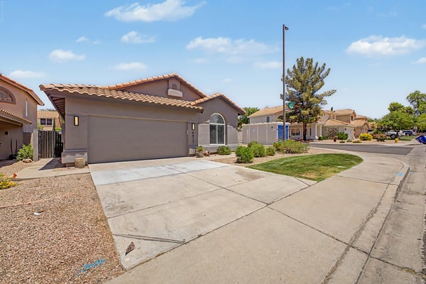 Large driveway leading to an attached two-car garage complete with built-in storage cabinets and a garage door opener. Functional parking and storage make everyday living even more convenient.