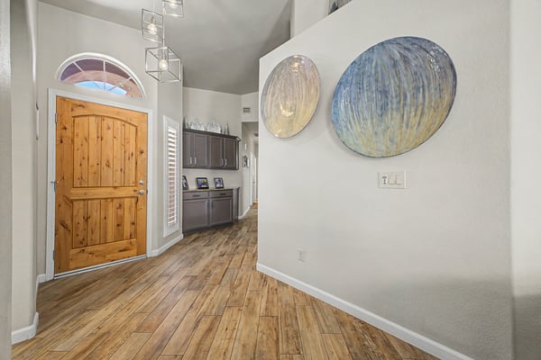 Open-concept living room with vaulted ceilings, abundant natural light, and easy access to the outdoor living space. Perfect for entertaining family and friends or relaxing at home.