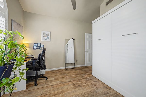 Flexible living space featuring tile flooring, abundant natural light, plantation shutters, and vaulted ceilings. Easily serves as a bedroom, office, or hobby room.