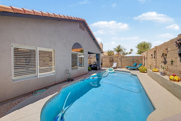 Inviting backyard with a sparkling swimming pool, generous patio space, and easy-care landscaping. Perfect for outdoor recreation, entertaining, or simply relaxing while enjoying the Arizona sunshine in Mesa.