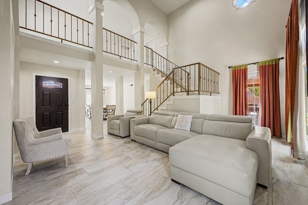 The spacious main living area combines soaring ceilings, classic architectural details, and a flowing floor plan with abundant natural light to create an inviting space perfect for relaxing or entertaining.
