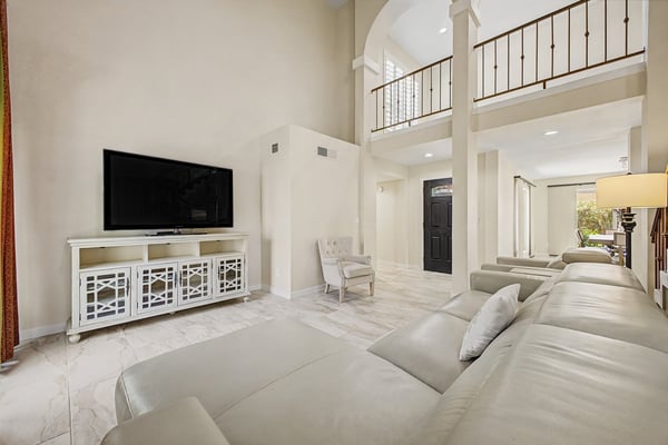 Enjoy a bright and open great room with updated flooring, soaring ceilings, and generous space for entertaining. Large windows enhance the home's airy feel while connecting the indoor and outdoor living areas.