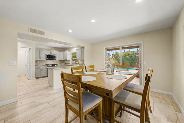 This spacious dining area connects effortlessly to the updated kitchen, creating a welcoming environment for gatherings. Natural light, backyard views, and an open floor plan make entertaining easy.