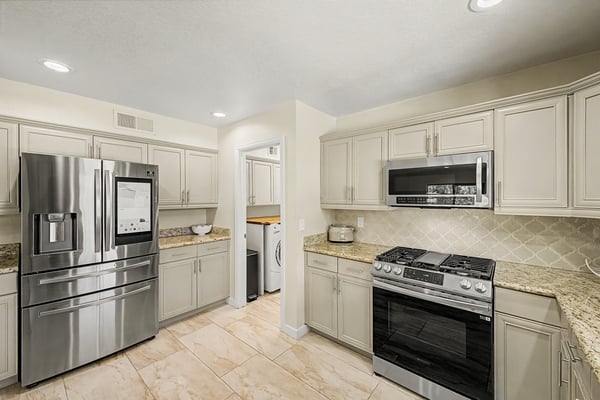 Updated cabinetry, granite countertops, stainless steel appliances, and recessed lighting combine to create a stylish kitchen that's both functional and inviting. A perfect gathering space for everyday living.