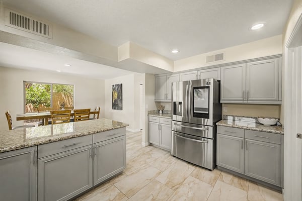 The kitchen's open-concept design provides easy access to the dining area while offering extensive cabinetry, granite countertops, and plenty of prep space. An ideal setup for hosting family and friends.