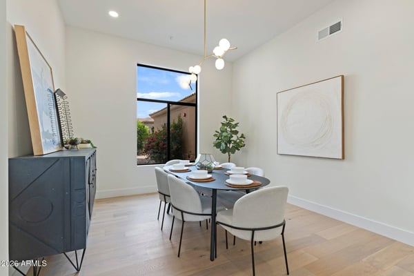 Sophisticated dining space with abundant natural light, stylish fixtures, and an open, airy feel. Designed to blend seamlessly with the home's modern layout while offering the perfect setting for gatherings.