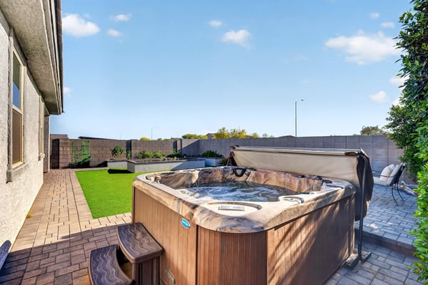 Relax in your own backyard spa surrounded by attractive pavers, lush artificial turf, raised planter beds, and thoughtfully designed outdoor gathering spaces.
