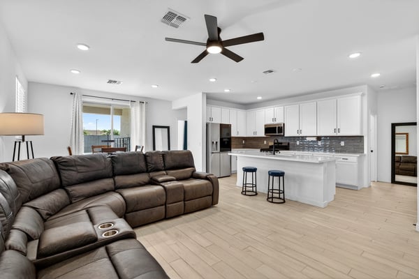 Designed for everyday comfort, the spacious great room features durable wood-look flooring, recessed lighting, ceiling fan, and an open connection to the kitchen for easy entertaining.