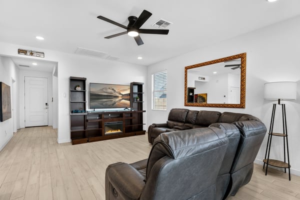 This welcoming living area showcases an open-concept design with modern finishes, abundant natural light, and comfortable gathering spaces that flow seamlessly throughout the home.