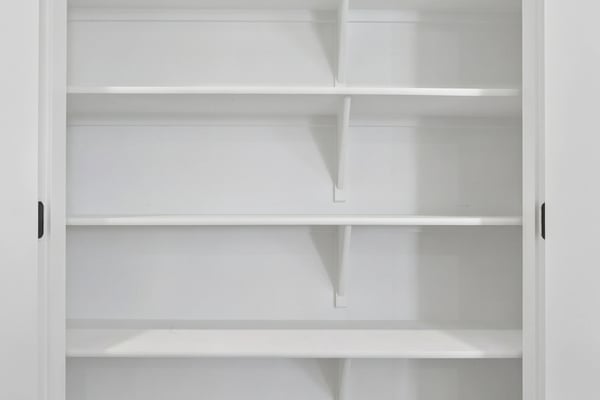 This generously sized pantry offers multiple built-in shelves to keep kitchen essentials organized while maximizing storage and convenience for everyday living.