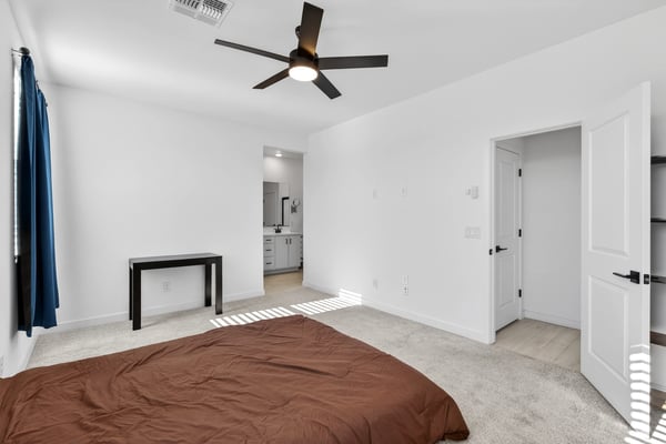 Featuring generous dimensions, soft natural light, neutral finishes, and direct access to the ensuite bath, this comfortable primary bedroom creates a relaxing owner's retreat.