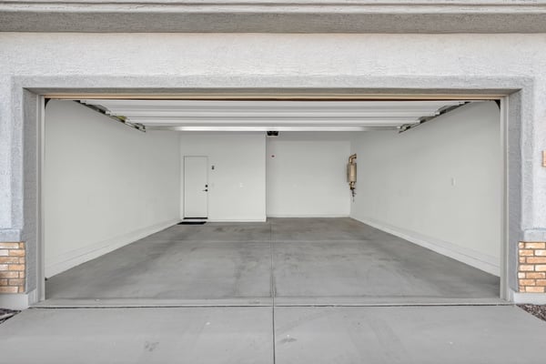 A clean and spacious attached two-car garage provides room for vehicles, storage, recreational equipment, and convenient access into the home.