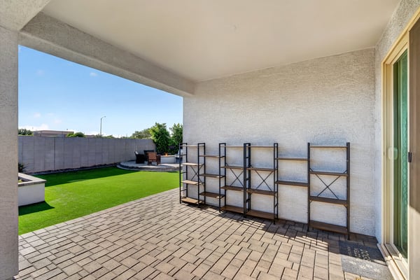 Enjoy shaded outdoor living beneath the covered patio while overlooking the beautifully landscaped backyard with low-maintenance artificial turf and entertaining spaces.