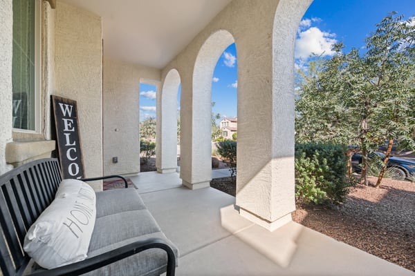 Covered front patio with elegant arches provides a peaceful place to unwind while welcoming guests in style. A beautiful outdoor feature that enhances everyday living.
