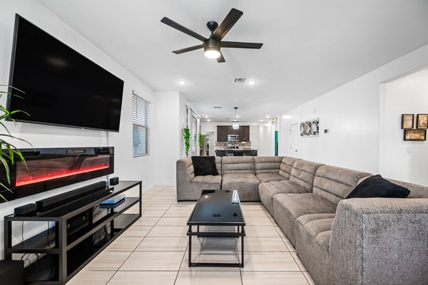 Another view of the spacious great room highlighting the open floor plan, stylish finishes, modern lighting, and easy flow throughout the home's main living areas.