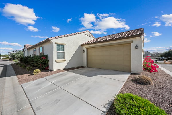 Attached two-car garage with spacious driveway parking and well-maintained exterior. Adds convenience and complements the attractive curb appeal of this Goodyear home.