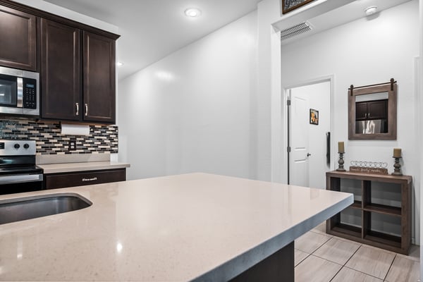 Clean hallway connecting the kitchen and secondary bedrooms while enhancing the home's efficient floor plan and providing convenient access to private living spaces.