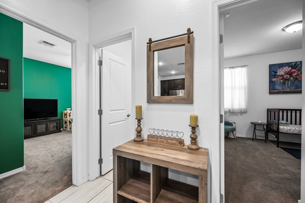 Hallway leading to the secondary bedrooms, creating separation between living and sleeping areas while adding functionality to this thoughtfully designed Goodyear home.