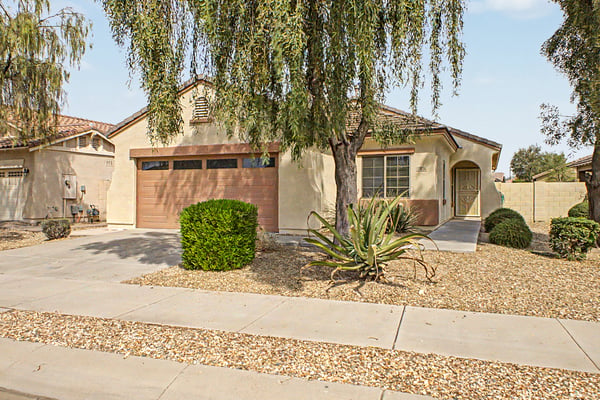 Inviting single-story home with mature landscaping, a spacious driveway, attached 2-car garage, and attractive curb appeal in the highly desirable Palm Valley community of Goodyear.