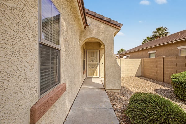 Covered front porch with an elegant security door and charming architectural details that provide a warm welcome and enhance the home's curb appeal.