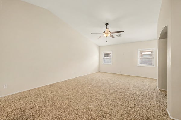 Generous family room with high ceilings, natural light, and versatile space that easily accommodates everyday living, entertaining, or relaxing with family and friends.