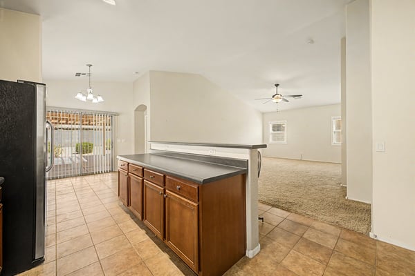 Open kitchen overlooking the dining and living areas with abundant storage, expansive countertops, and a functional layout designed for modern living in Goodyear.