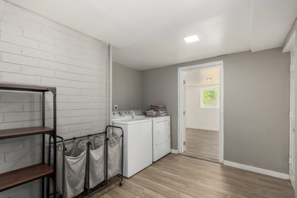 Spacious laundry and utility room with durable flooring, washer and dryer hookups, and room for storage or organization. Designed to simplify daily routines while adding practical functionality to this Mesa property.