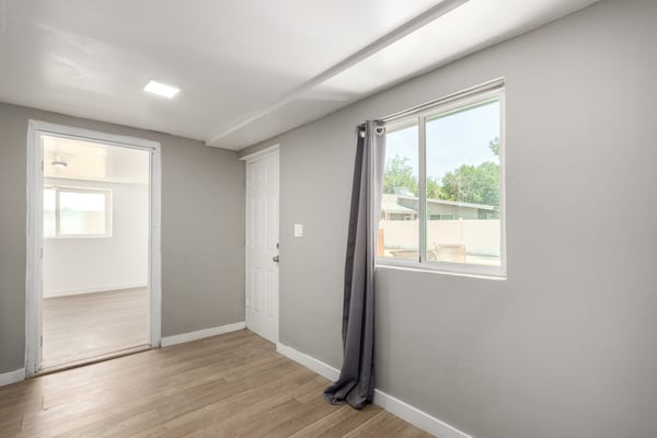 Bright bonus room with updated flooring and a flexible layout ideal for a home office, playroom, hobby room, fitness area, media room, or additional family living space. A versatile extension of this well-maintained Mesa home.