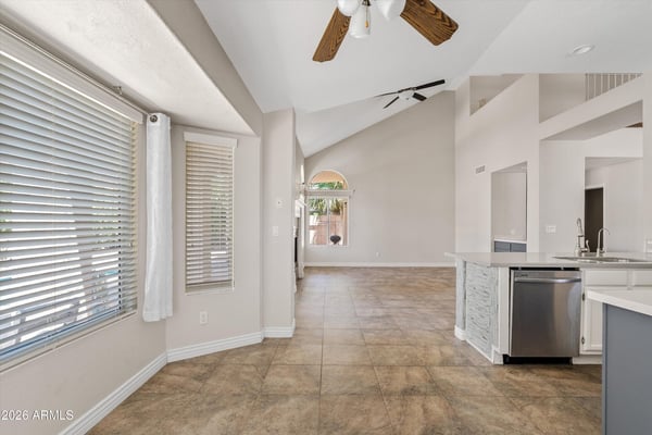 Large windows fill the breakfast nook with natural light while offering views toward the backyard and pool. Conveniently located next to the updated kitchen, this welcoming space is ideal for casual dining.